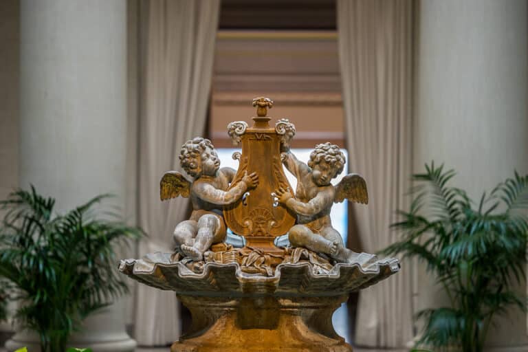 Formal garden with sculpture outside an art museum building