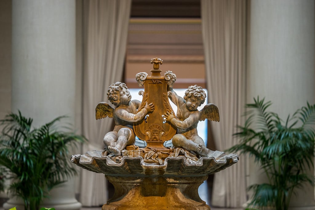 Formal garden with sculpture outside an art museum building